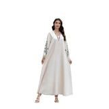Dubai Muslim women's abaya. It is a fashionable and elegant dress in Arabic style with a V-neck embroidered patterns and tassels