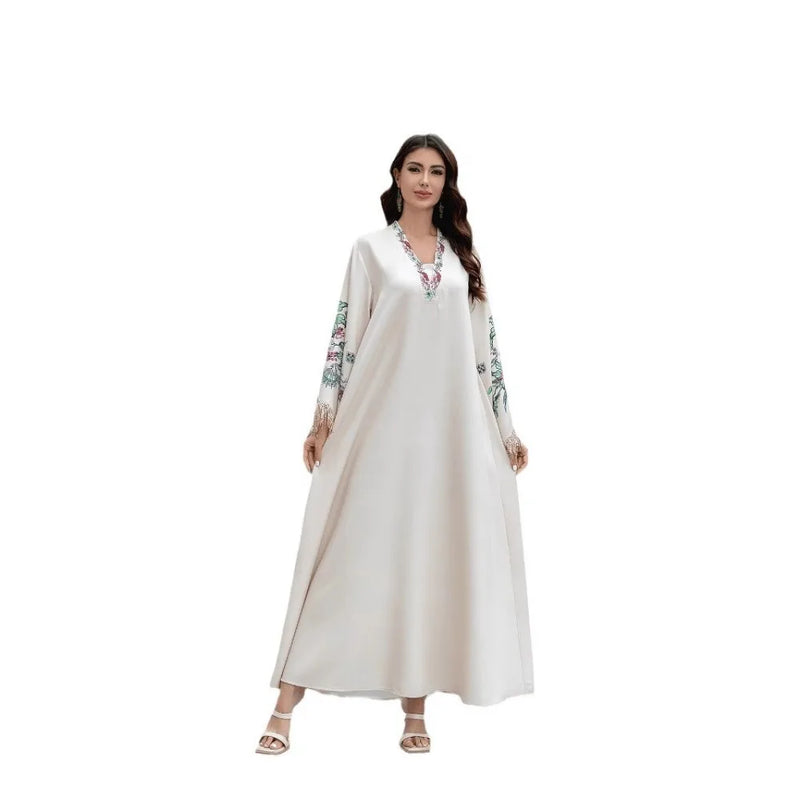 Dubai Muslim women's abaya. It is a fashionable and elegant dress in Arabic style with a V-neck embroidered patterns and tassels