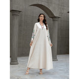 Dubai Muslim women's abaya. It is a fashionable and elegant dress in Arabic style with a V-neck embroidered patterns and tassels