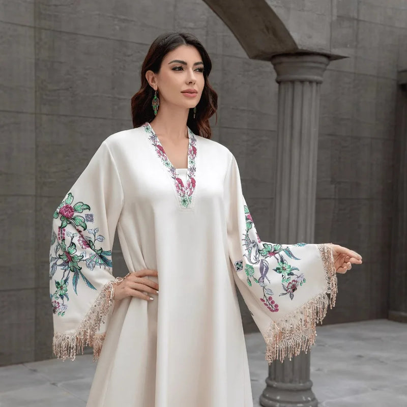 Dubai Muslim women's abaya. It is a fashionable and elegant dress in Arabic style with a V-neck embroidered patterns and tassels