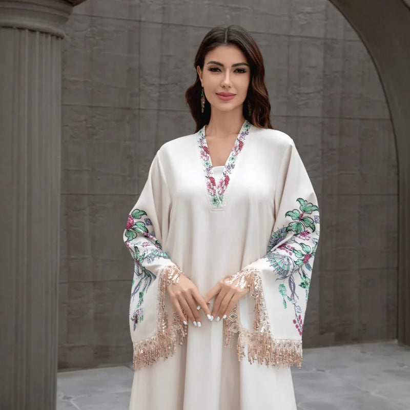 Dubai Muslim women's abaya. It is a fashionable and elegant dress in Arabic style with a V-neck embroidered patterns and tassels