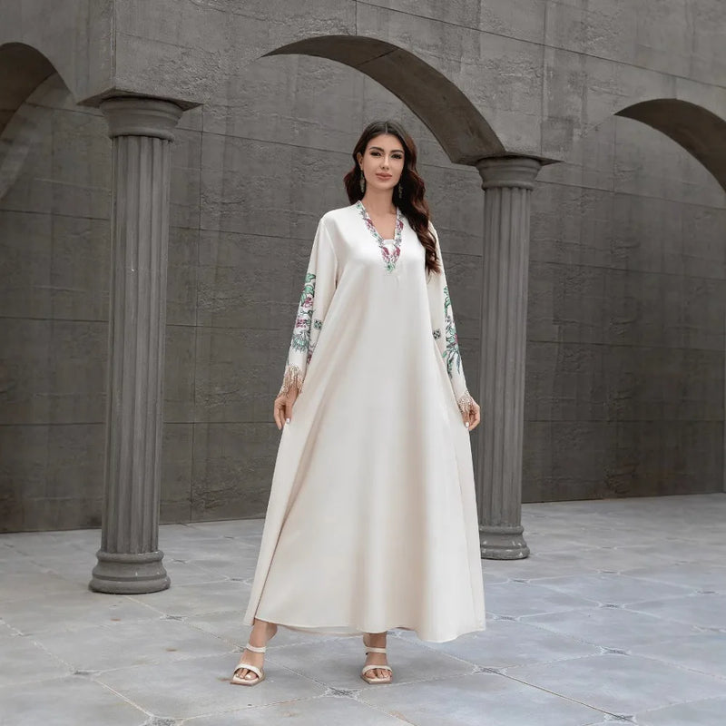 Dubai Muslim women's abaya. It is a fashionable and elegant dress in Arabic style with a V-neck embroidered patterns and tassels
