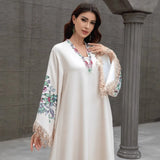 Dubai Muslim women's abaya. It is a fashionable and elegant dress in Arabic style with a V-neck embroidered patterns and tassels